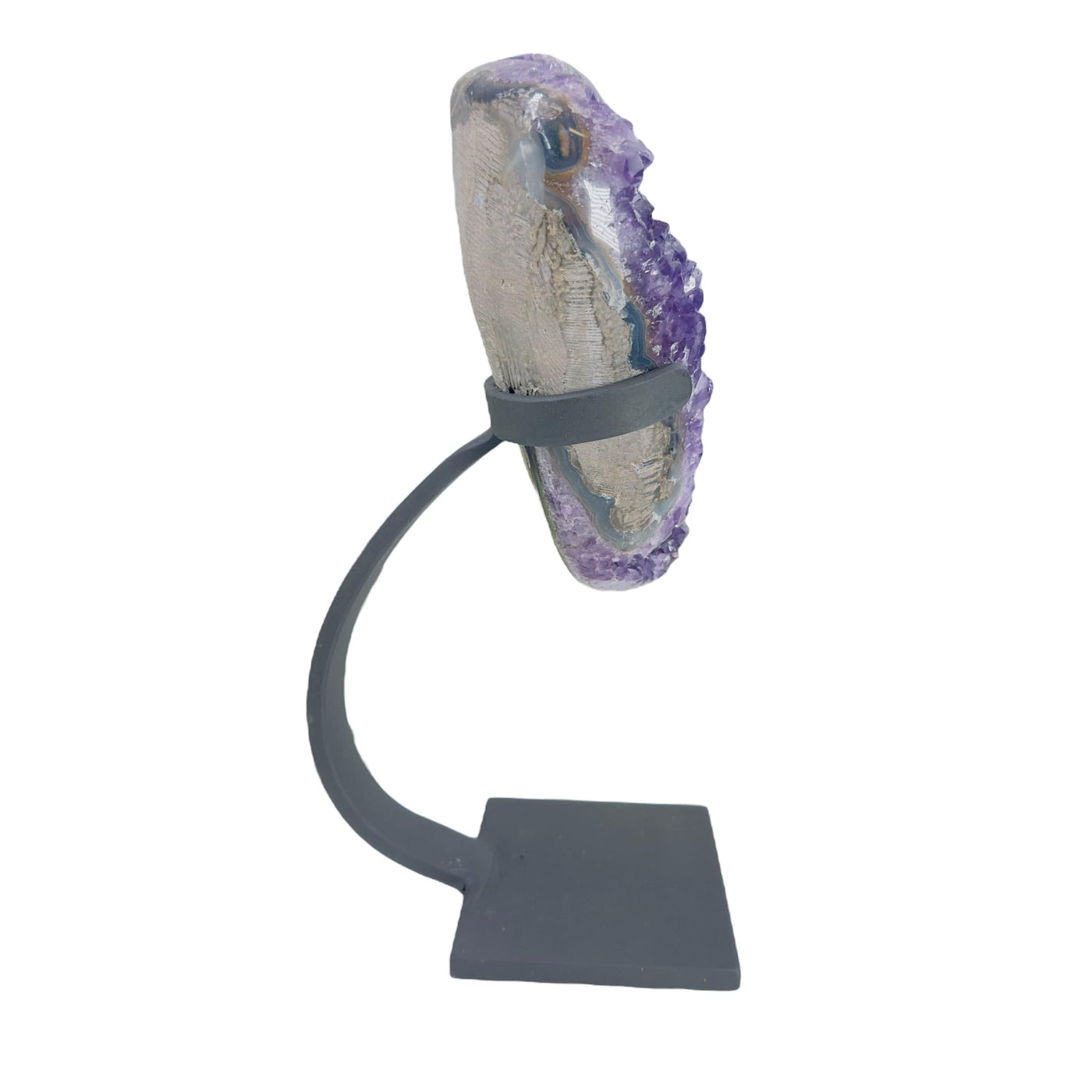 side view of amethyst on stand on white background