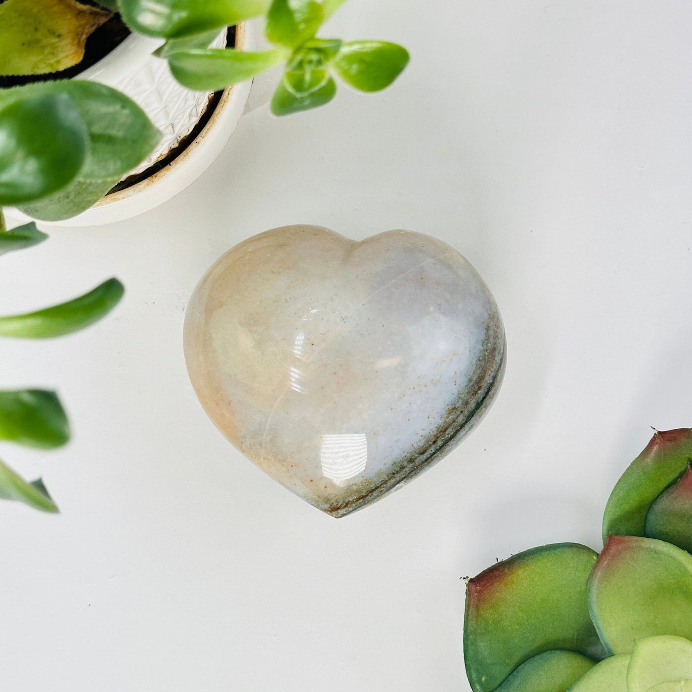 backside of Ocean Jasper Heart with decorations in the background