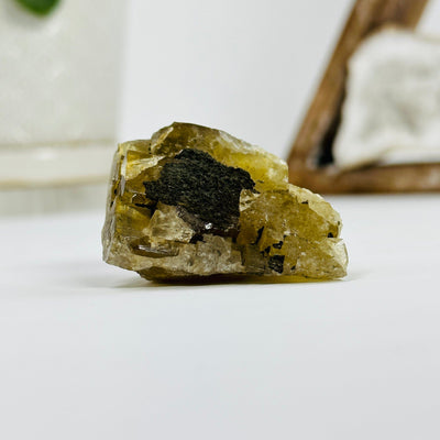 epidote cluster with decorations in the background
