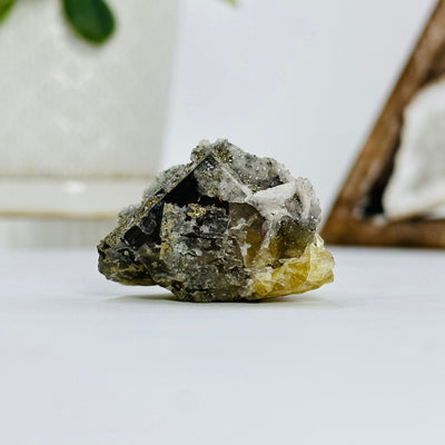 epidote with pyrite growth with decorations in the background