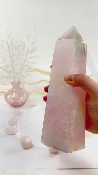 Angel Aura Rose Quartz Generator with Natural Inclusions video in hand to show iridescence