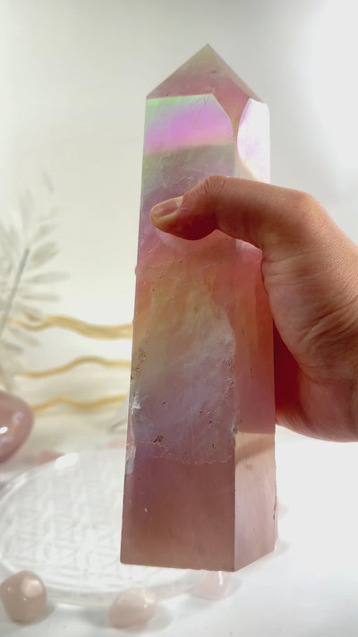 Angel Aura Rose Quartz Obelisk with Natural Inclusions video in hand to show iridescence