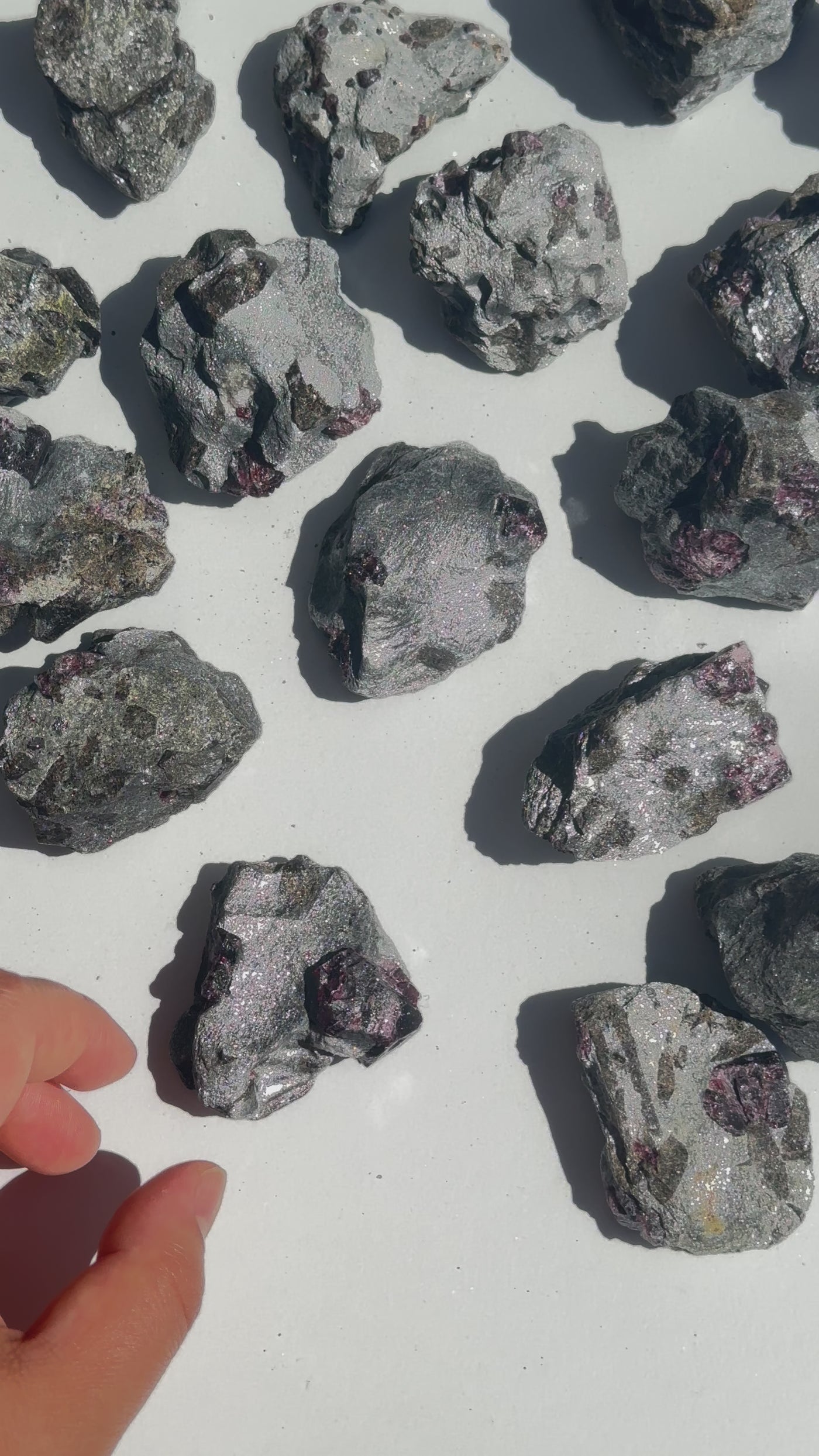 Garnet on Hematite Matrix - Natural Crystal video of hand picking up stone and turning it in the sun to see flashes