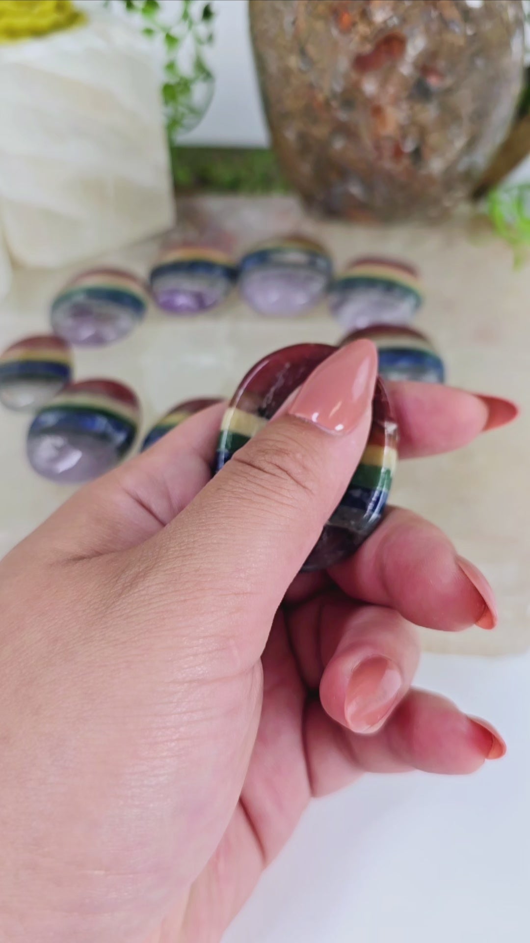 Seven Chakra Worry Stone video showing hand rubbing worry stone