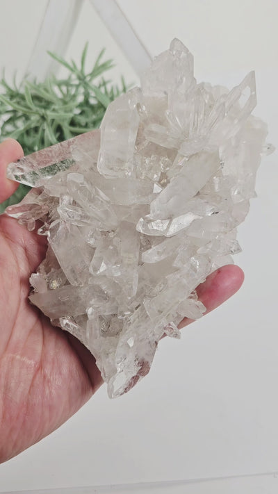 Lemurian Crystal Quartz Cluster - AA Grade - One-of-a-Kind in hand showing different angles catching the light