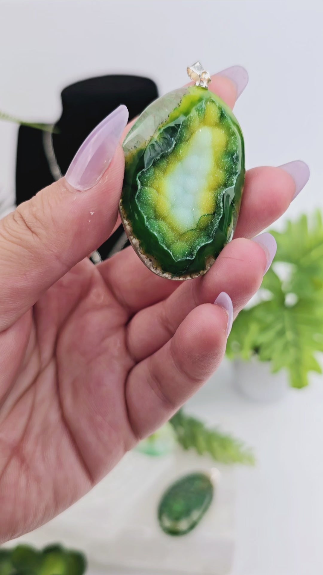 Agate Druzy Crystal Pendant - Dyed Green video showing hand moving pendant to show sparkly druzy