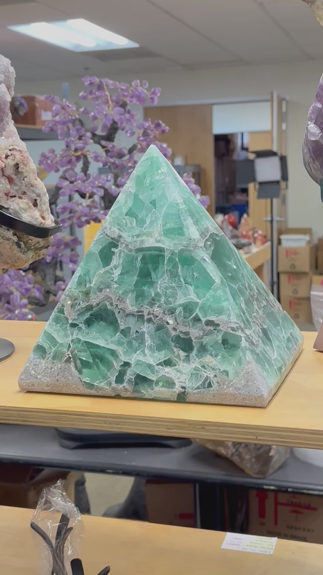 video of a large fluorite pyramid on a shelf.