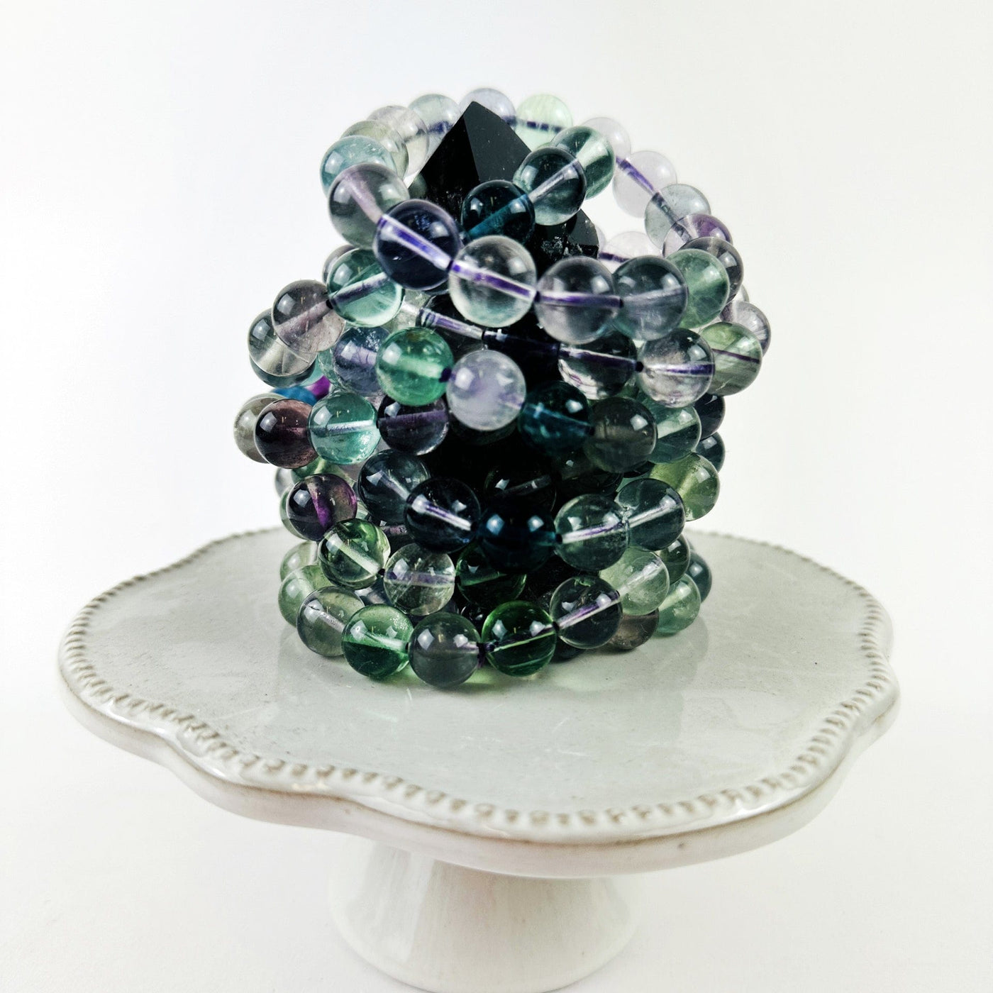 Rainbow Fluorite Round Bead Bracelets stacked on a table