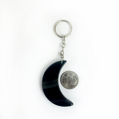 Crescent Moon Agate Key Chain next to a quarter showing size
