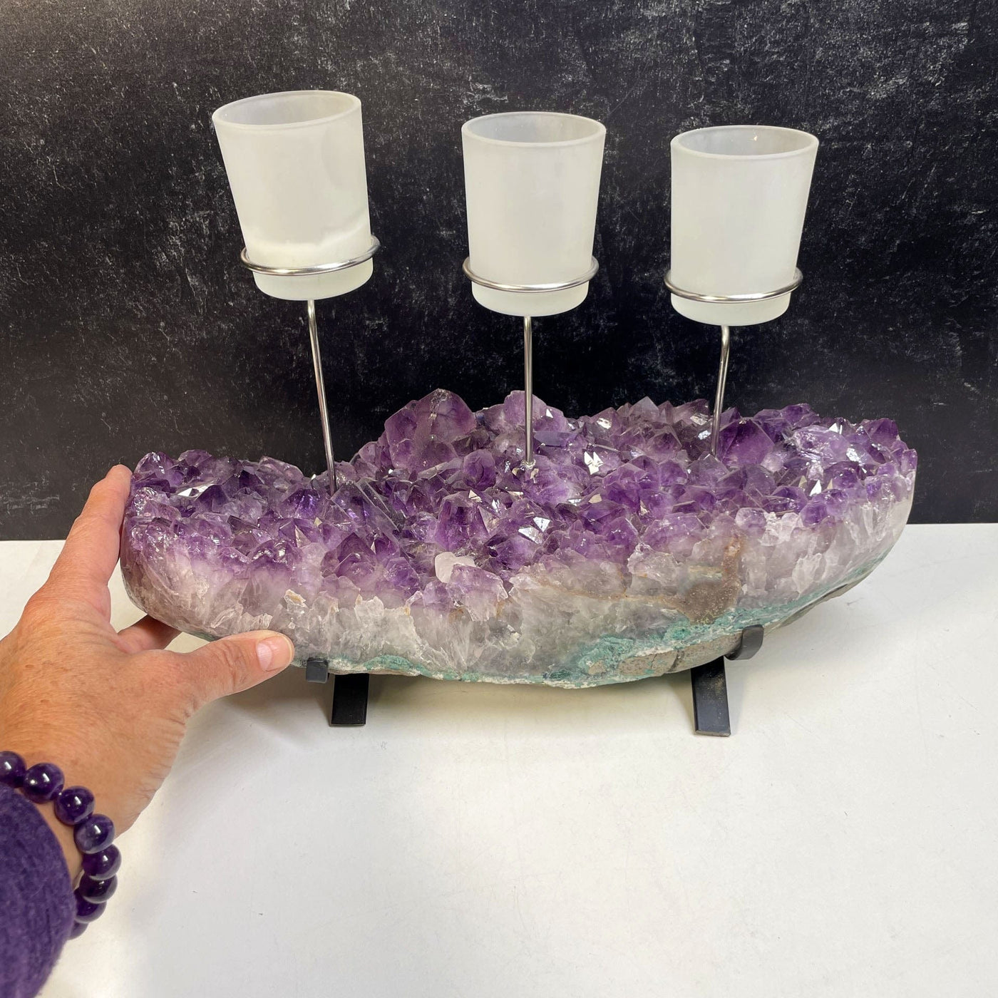 Amethyst Cluster Base with 3 Votive Candle Holders with a hand for size reference
