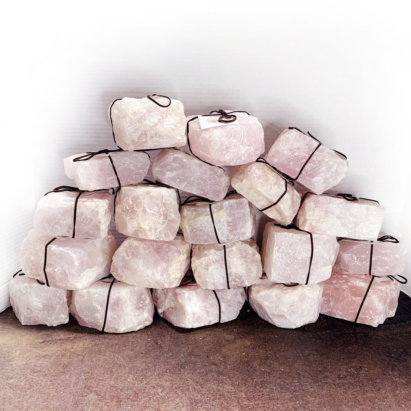 twenty rose quartz candle holders stacked up
