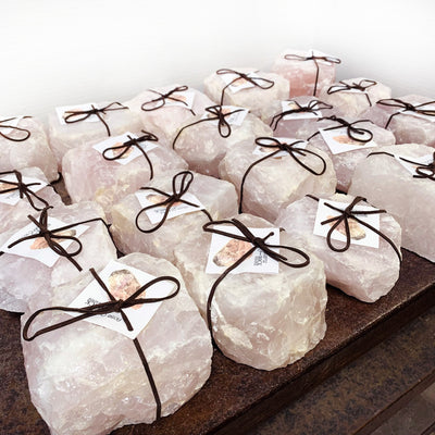 twenty rose quartz candle holders displayed on a table 
