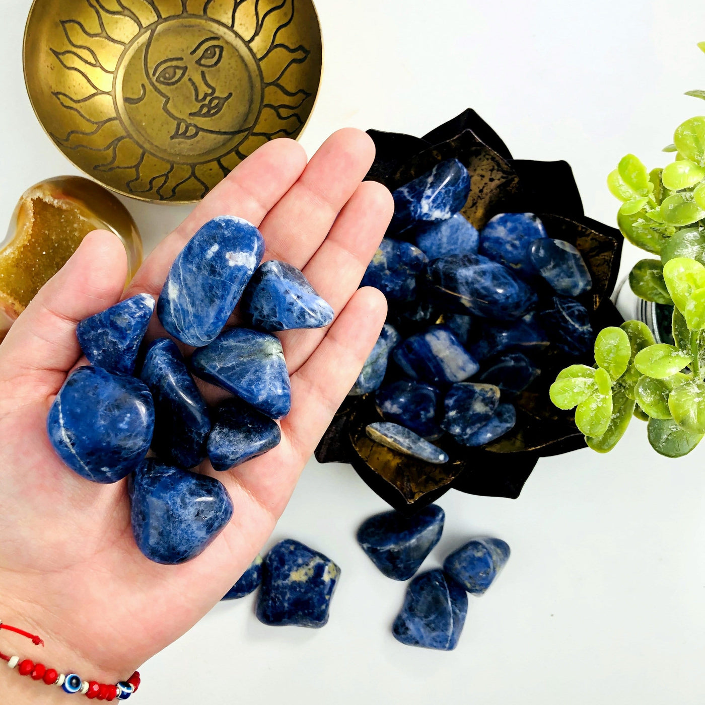 Blue Sodalite Tumbled Gemstones in a hand