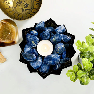 Blue Sodalite Tumbled Gemstones in a bowl with a votive in center