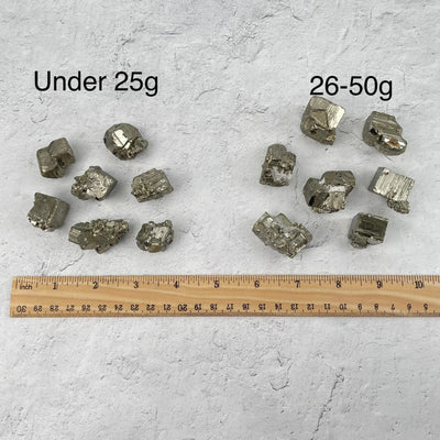 Pyrite Clusters and Cubes - by Weight. next to a ruler for size reference 