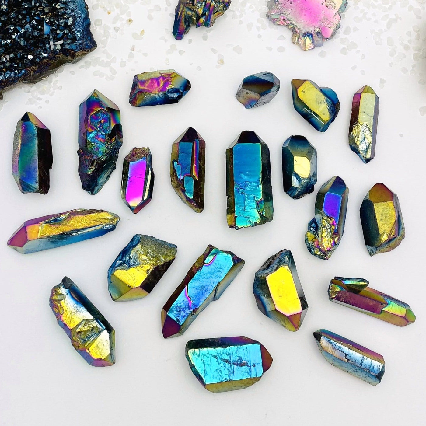 crystal quartz points coated in rainbow titanium showing the different colors and size variations 