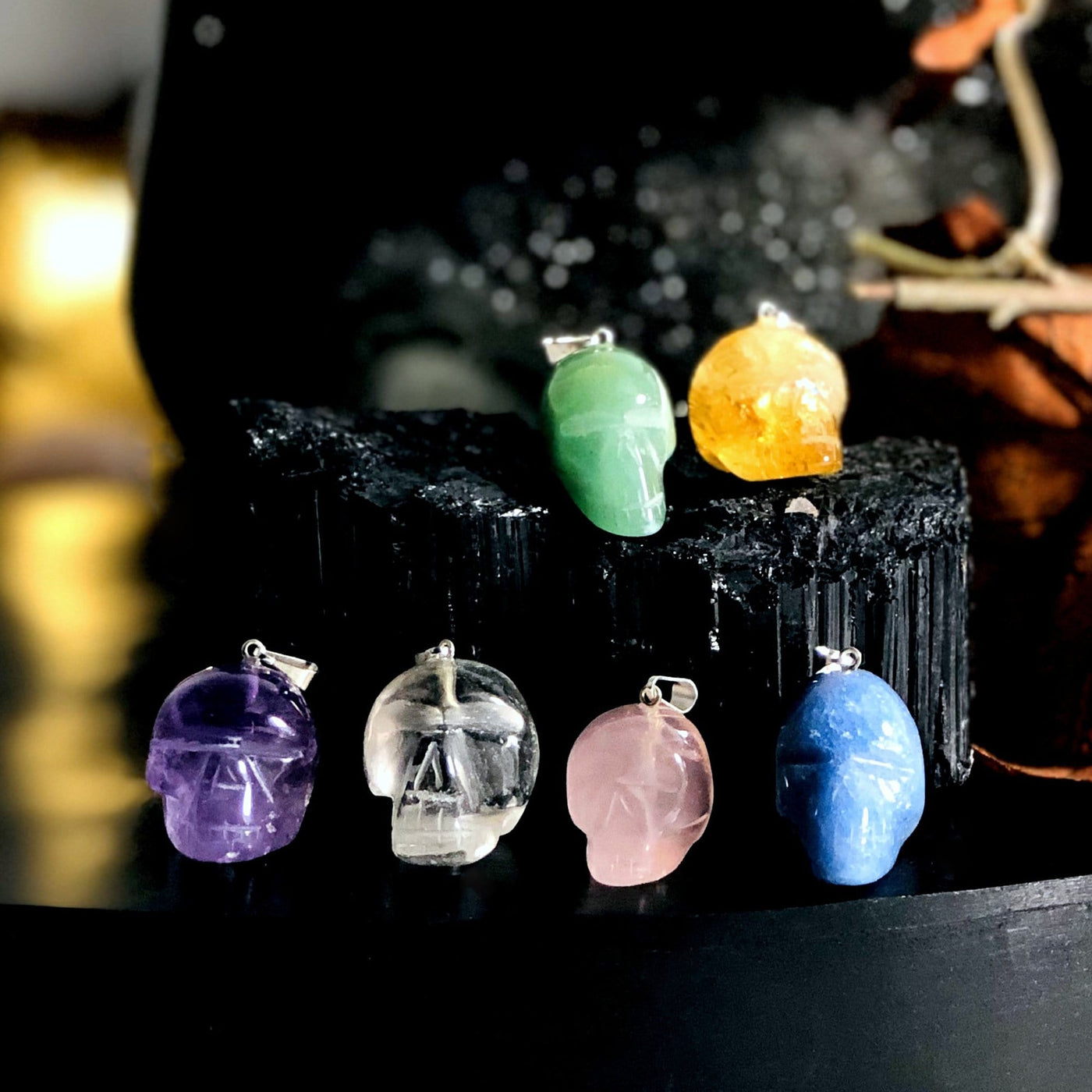 all skull shaped gemstone pendants on display