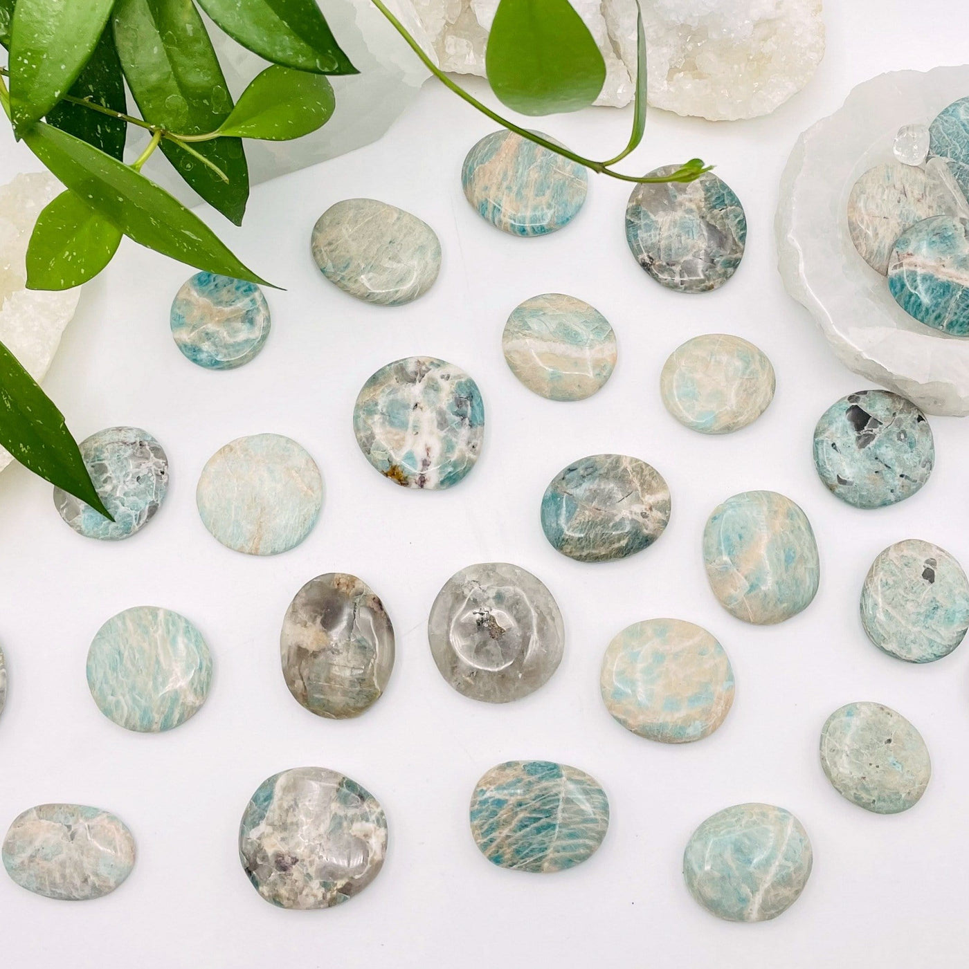 amazonite polished stones being displayed on a white background.