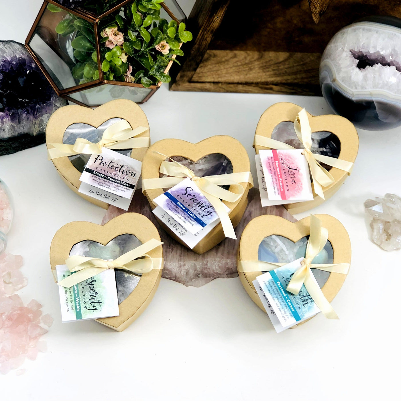 various heart boxes displayed with other crystals in the background