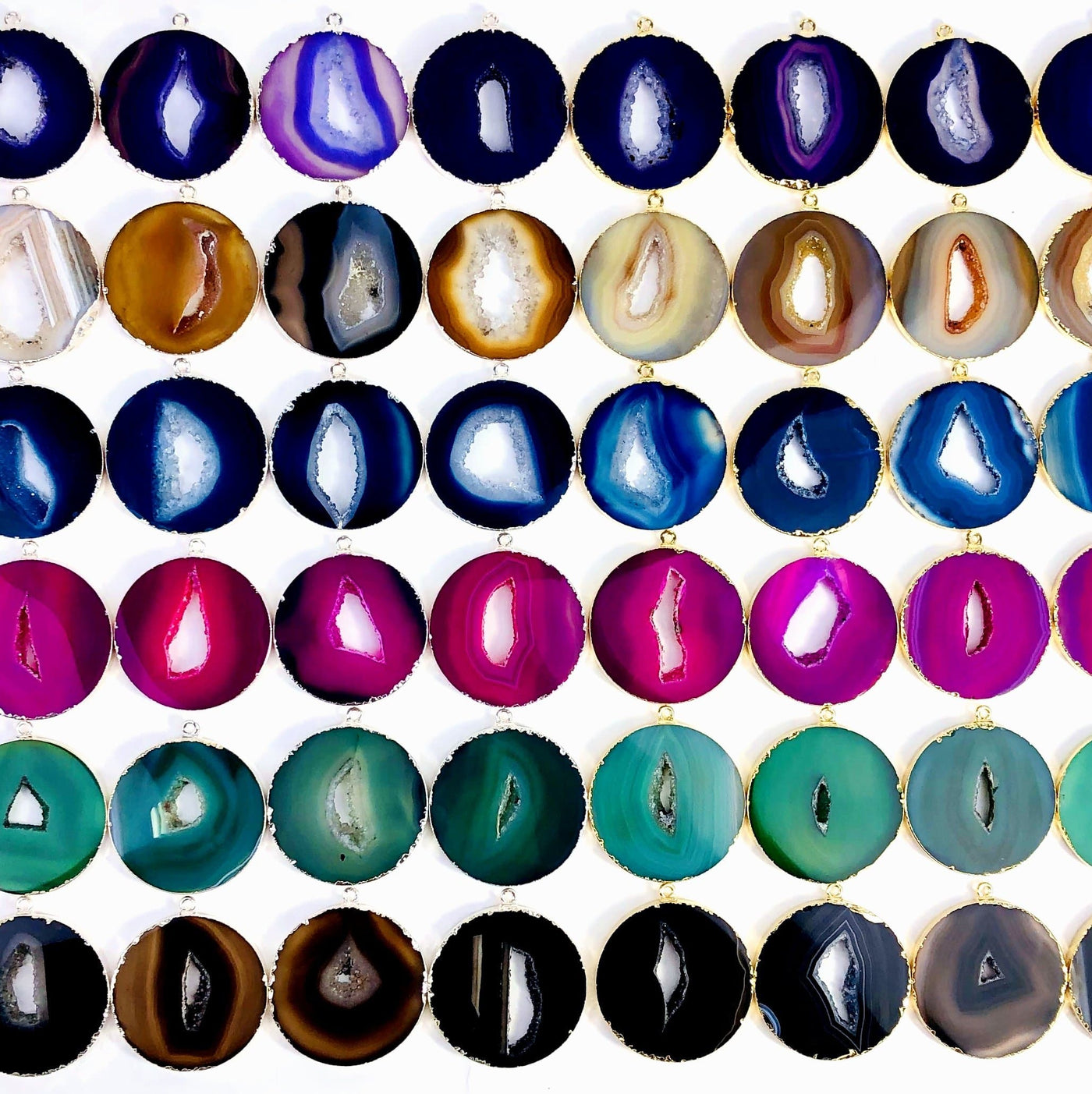 Multiple Agate Circle Slice Pendants front facing to display variation in pattern and color.