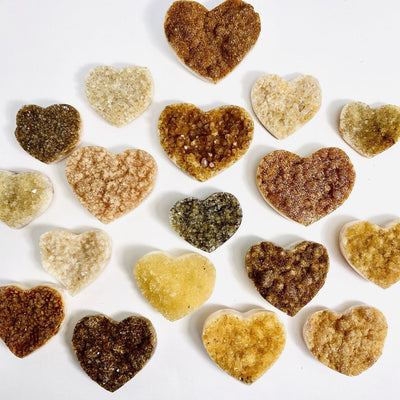 Citrine Cluster Druzy Hearts scattered on white background
