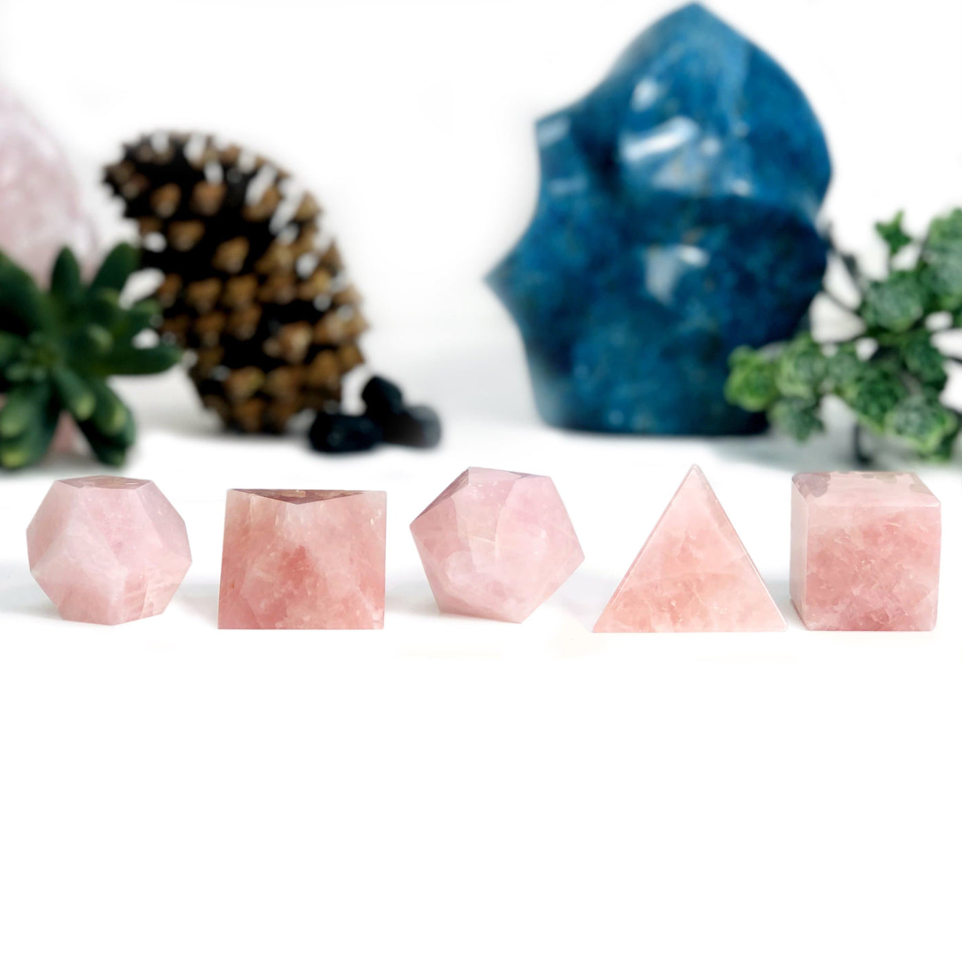 Rose Quartz Sacred Geometry Meditation Set lined up with other decorations burred in the background