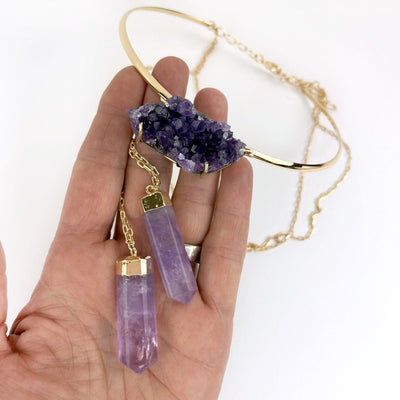 Amethyst Layering Necklace in a hand showing the stones: cluster and 2 points up close