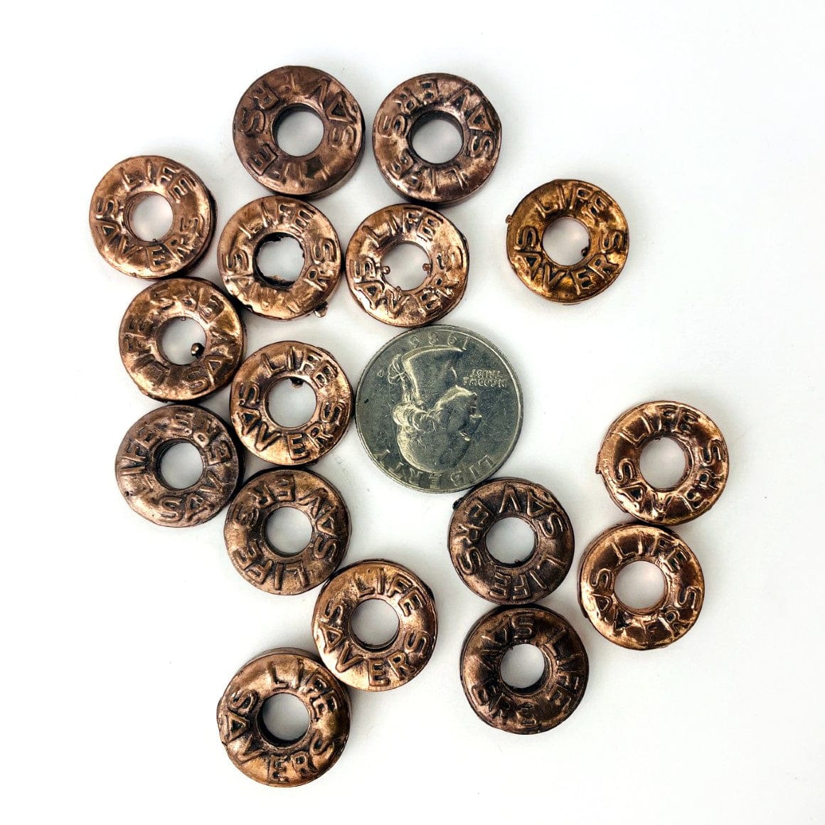 Copper Life Saver Pendant with a quarter for size reference