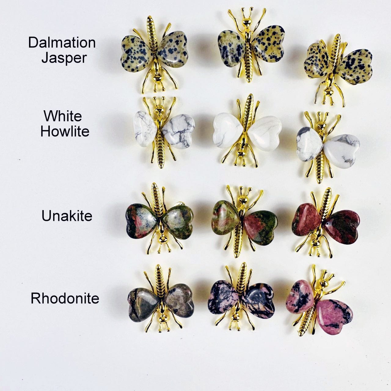 Gemstone Butterflies with Gold Tone Body on a table showing the assorted stones we carry and the stone name called out next to it