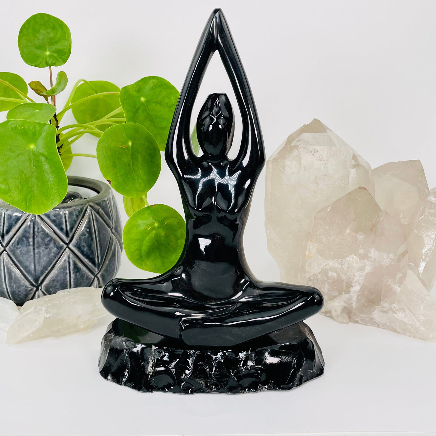 gold sheen obsidian carved into a meditating goddess displayed as home decor