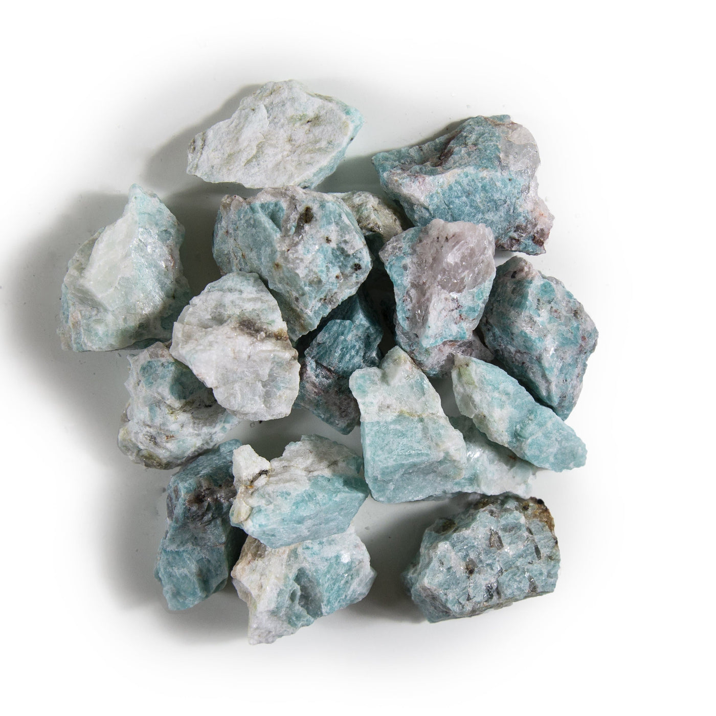 Picture of amazonite chunks being displayed on a white background.