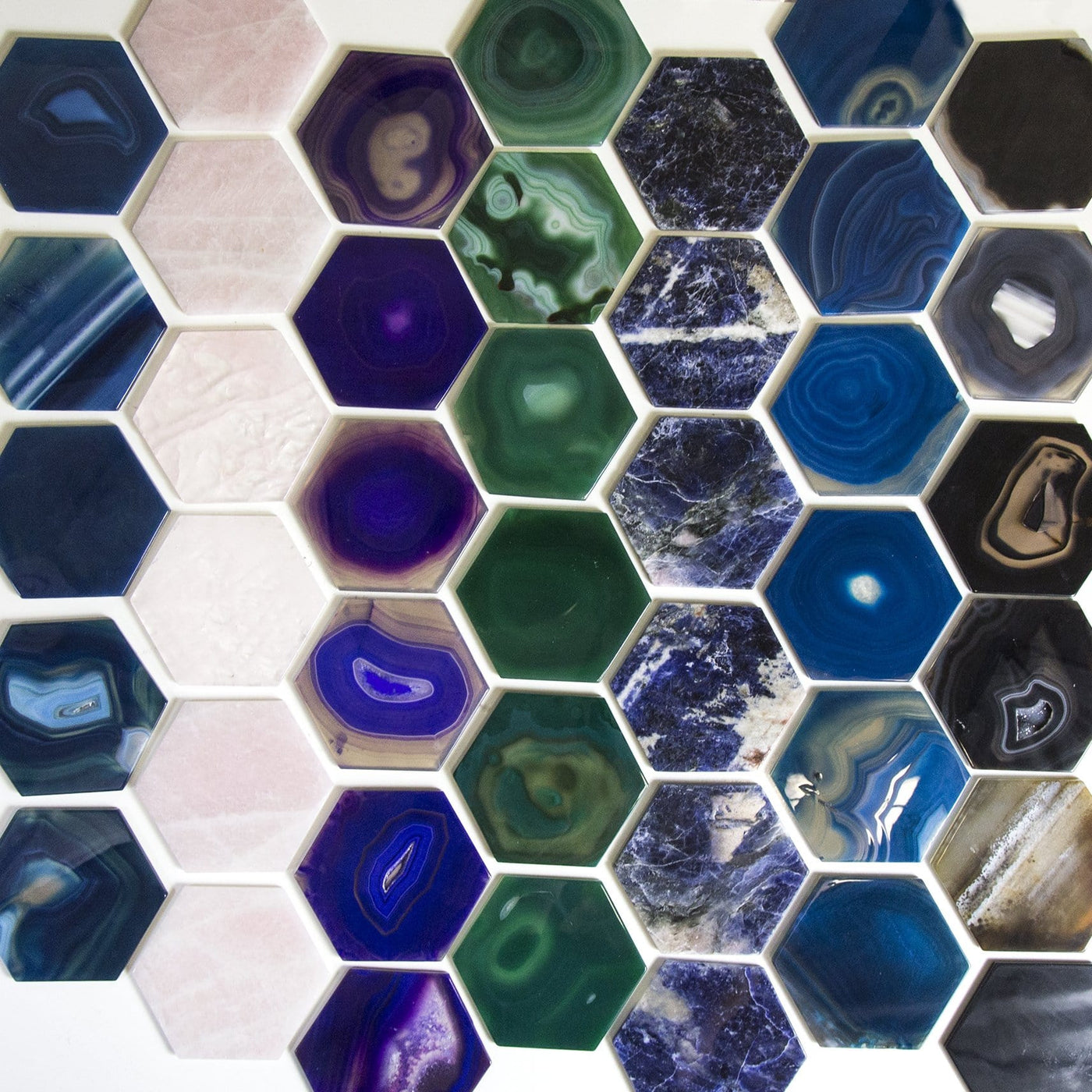 all colors of hexagon agates on a table