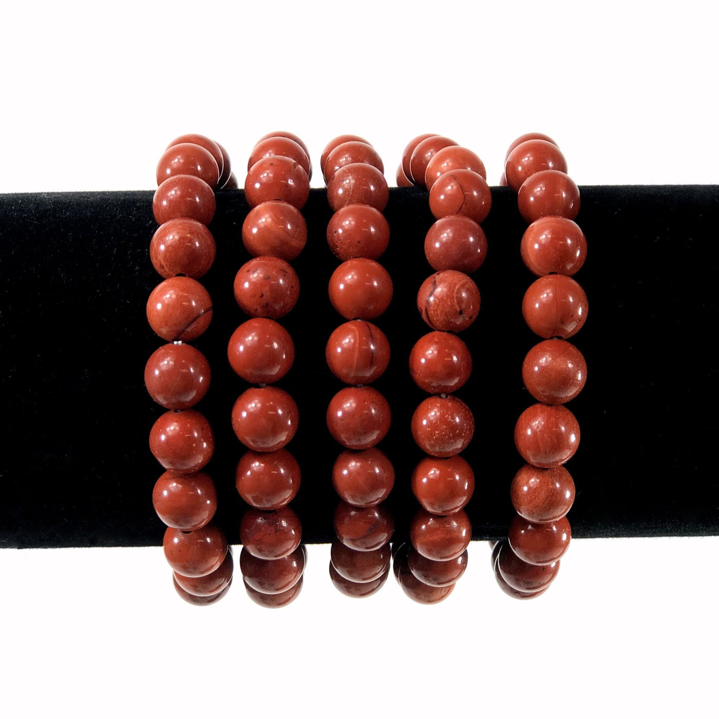red jasper healing stone bracelets on a display stand with white background