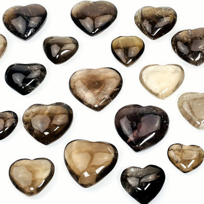 many smokey quartz polished hearts on white background for possible variations