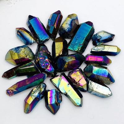 crystal quartz points coated in rainbow titanium showing the different colors and size variations