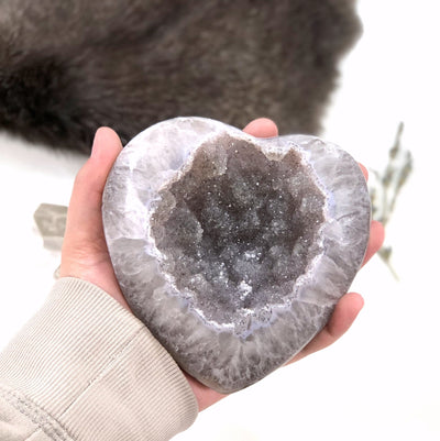 Front view of Polished Agate Druzy Gray Heart in a hand.