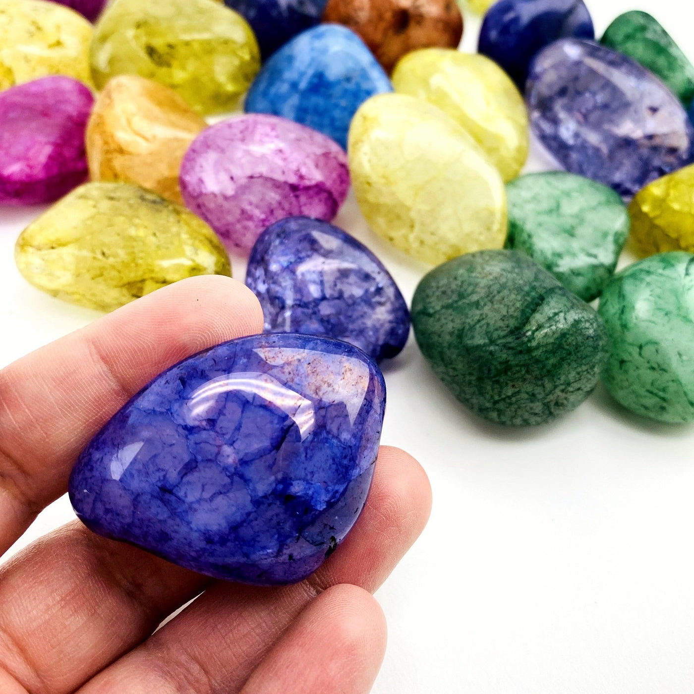 mixed tumbled stones and one in a hand