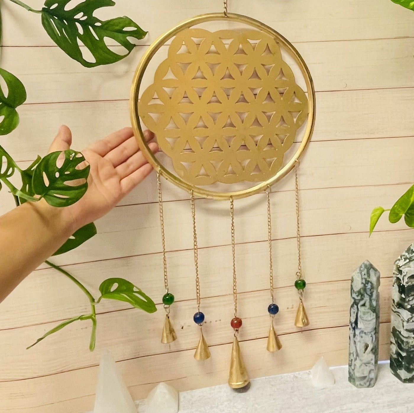 Brass Flower of Life wall Hanging - with a hand next to it