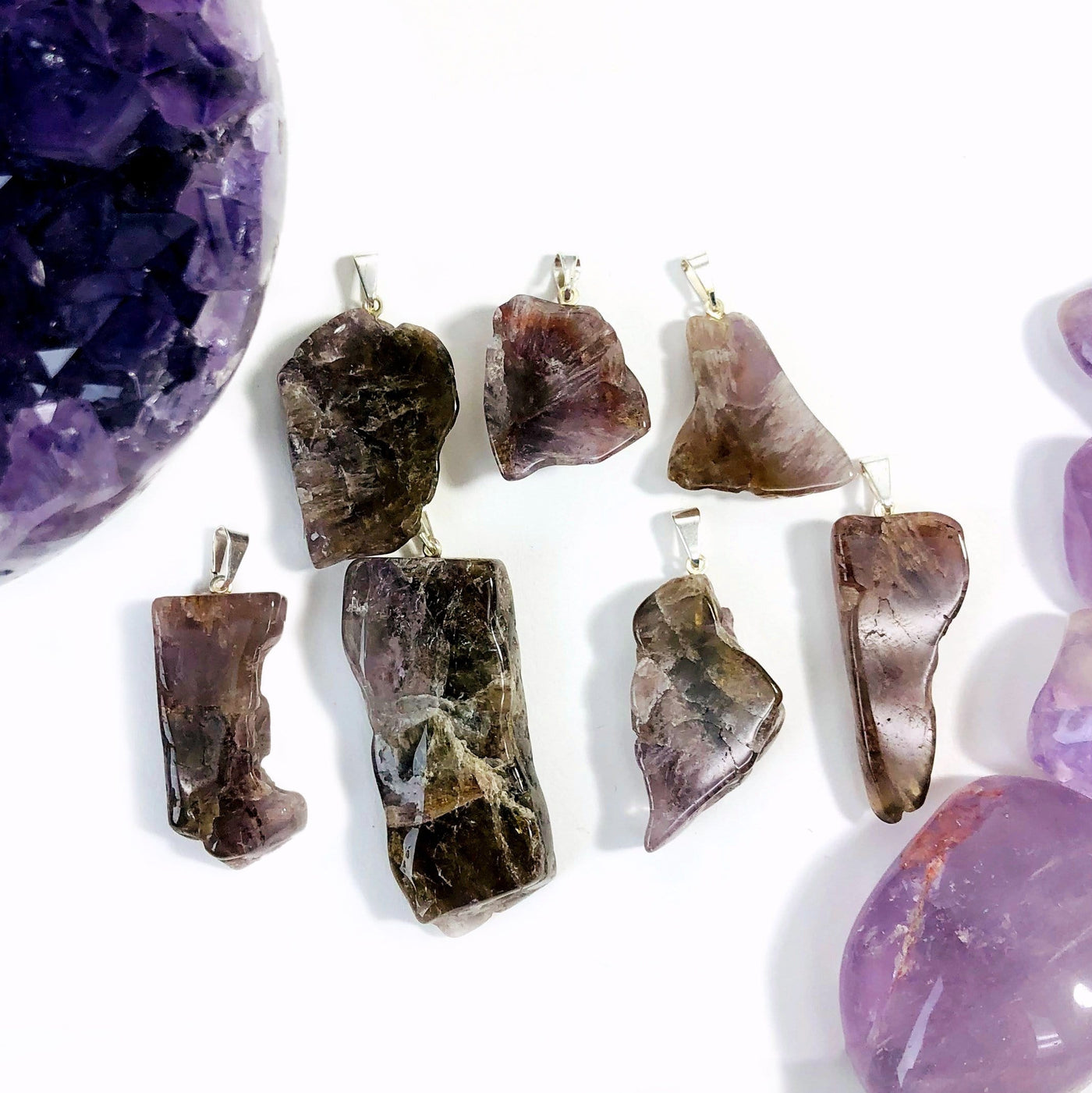 many seven minerals in one stone freeform slab pendants on display for possible variations
