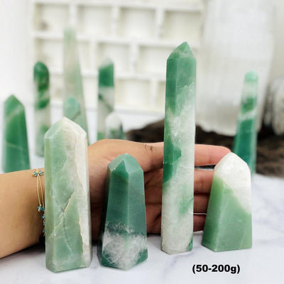 Green and White Quartz Polished Points--front view shot of 50 to 200 grams with different tones and sizes.