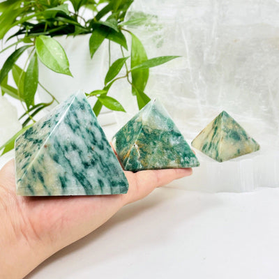 fuchsite pyramids in hand for size reference 