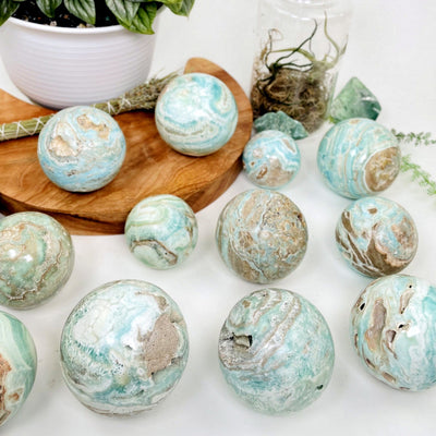 Blue Aragonite Spheres - Also known as Caribbean Calcite spred out on a table with different sizes