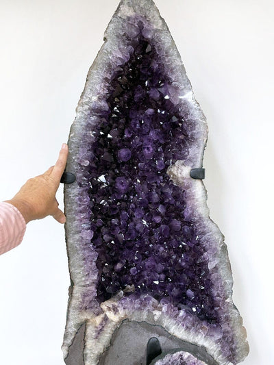 Amethyst Geode Cathedral on the top with a hand for the size reference