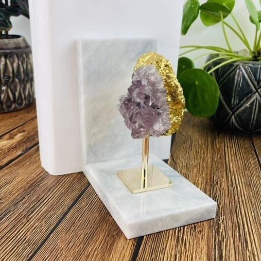 side shot of Amethyst Cluster on Gold Stand on Stone Bookends