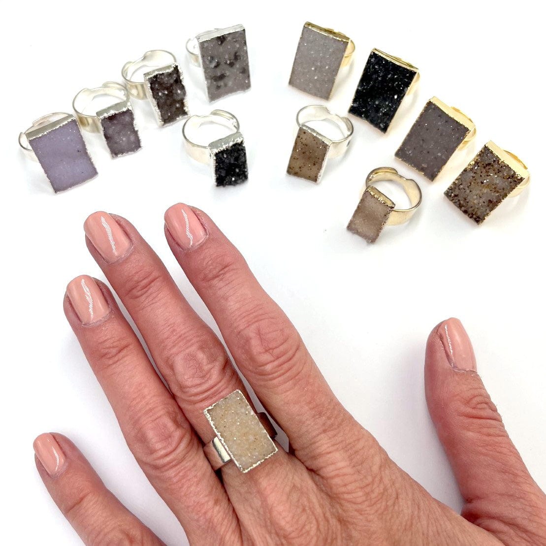 Quartz Druzy Rectangle Adjustable Ring on a hand and others in background showing different colors of druzy