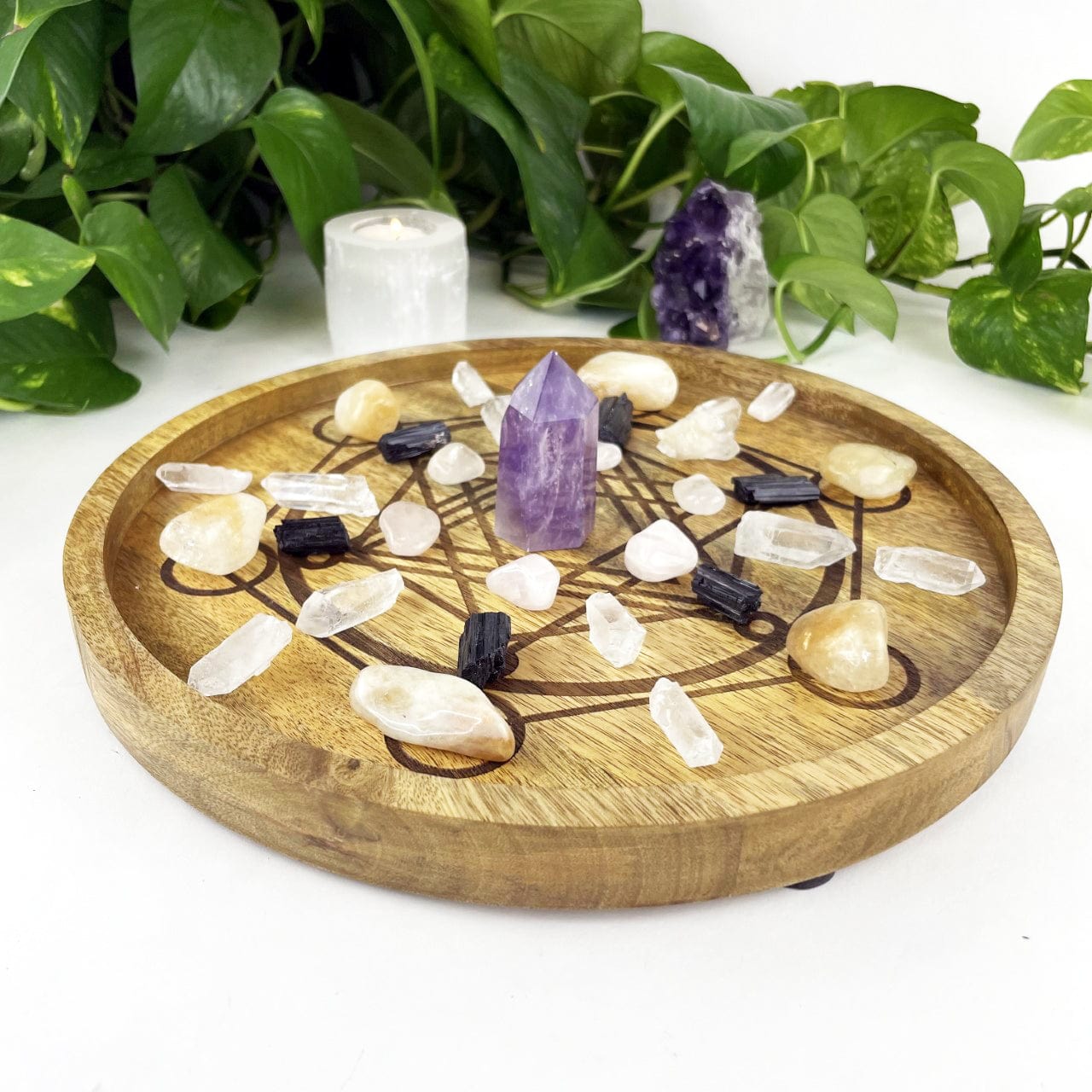 large Metatron Wood Tray in Mango Wood with crystals displayed inside and assorted crystals for decoration next to it on a white background