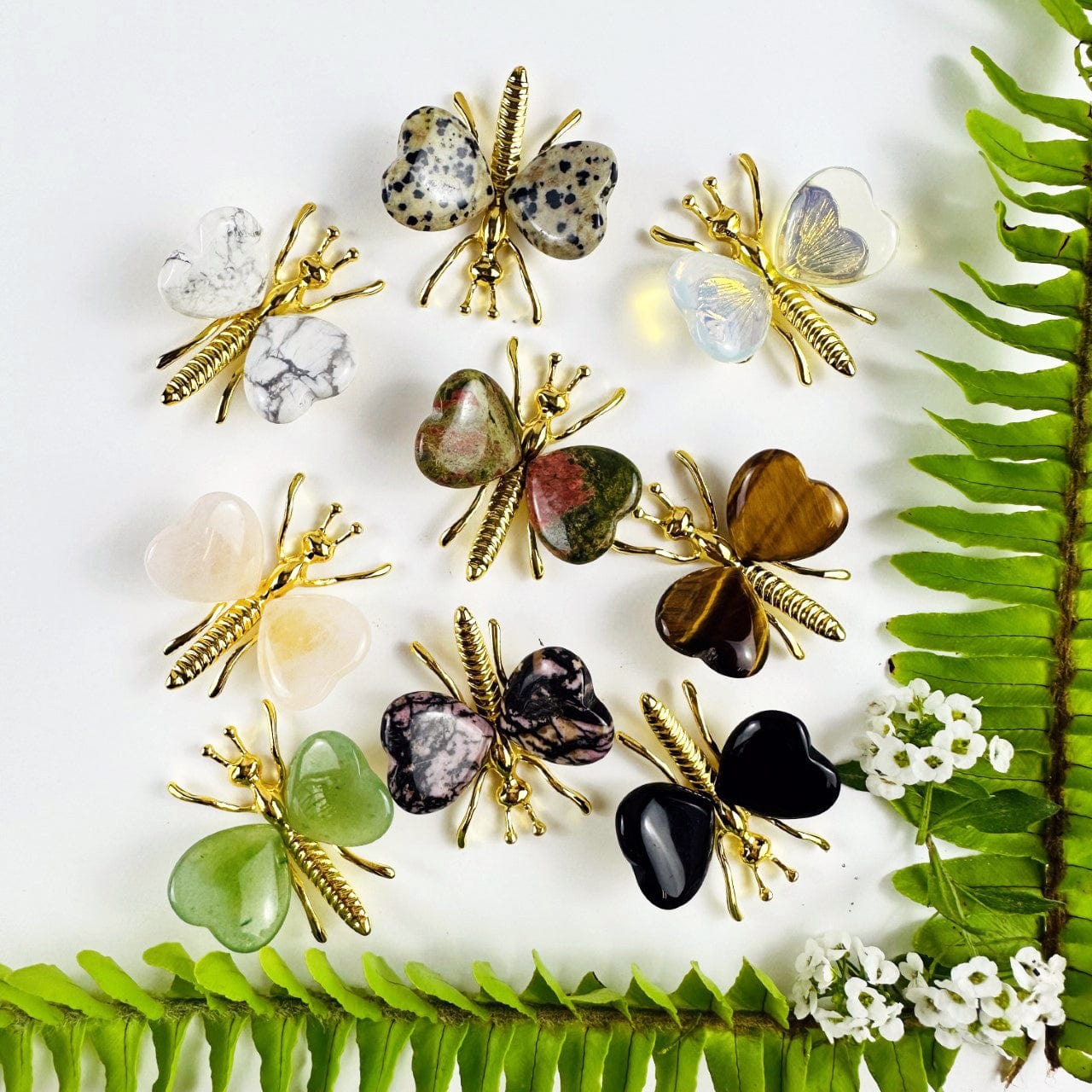 Gemstone Butterflies with Gold Tone Body on a table showing the assorted stones we carry