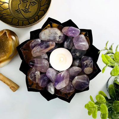 Amethyst Tumbled Gemstones in a bowl with a candle