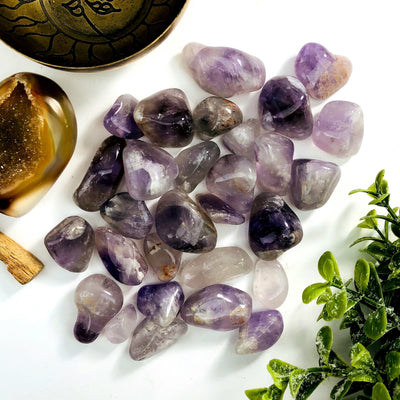 amethyst tumbled stones with decorations in the background