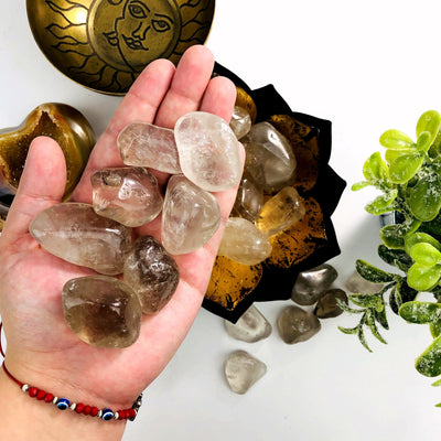 Smokey Quartz Tumbled Gemstones in a hand for size